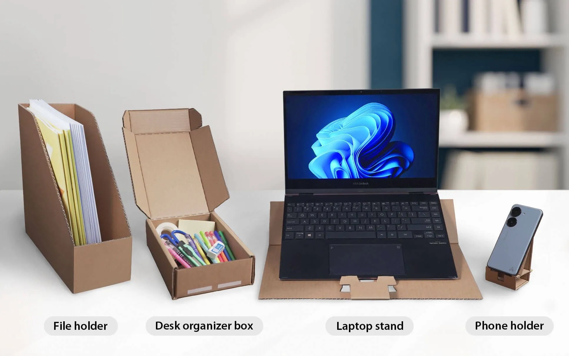 Bao bì tái sử dụng của màn hình Asus VU Air Ionizer được biến đổi thành giá đỡ điện thoại và hộp đựng bút, thể hiện cam kết bảo vệ môi trường.