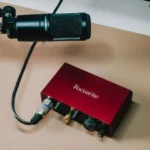 Giao diện âm thanh Focusrite Scarlett Solo Gen 3 với micro XLR được cắm sẵn, minh họa cho một hệ thống thu âm chuyên nghiệp.