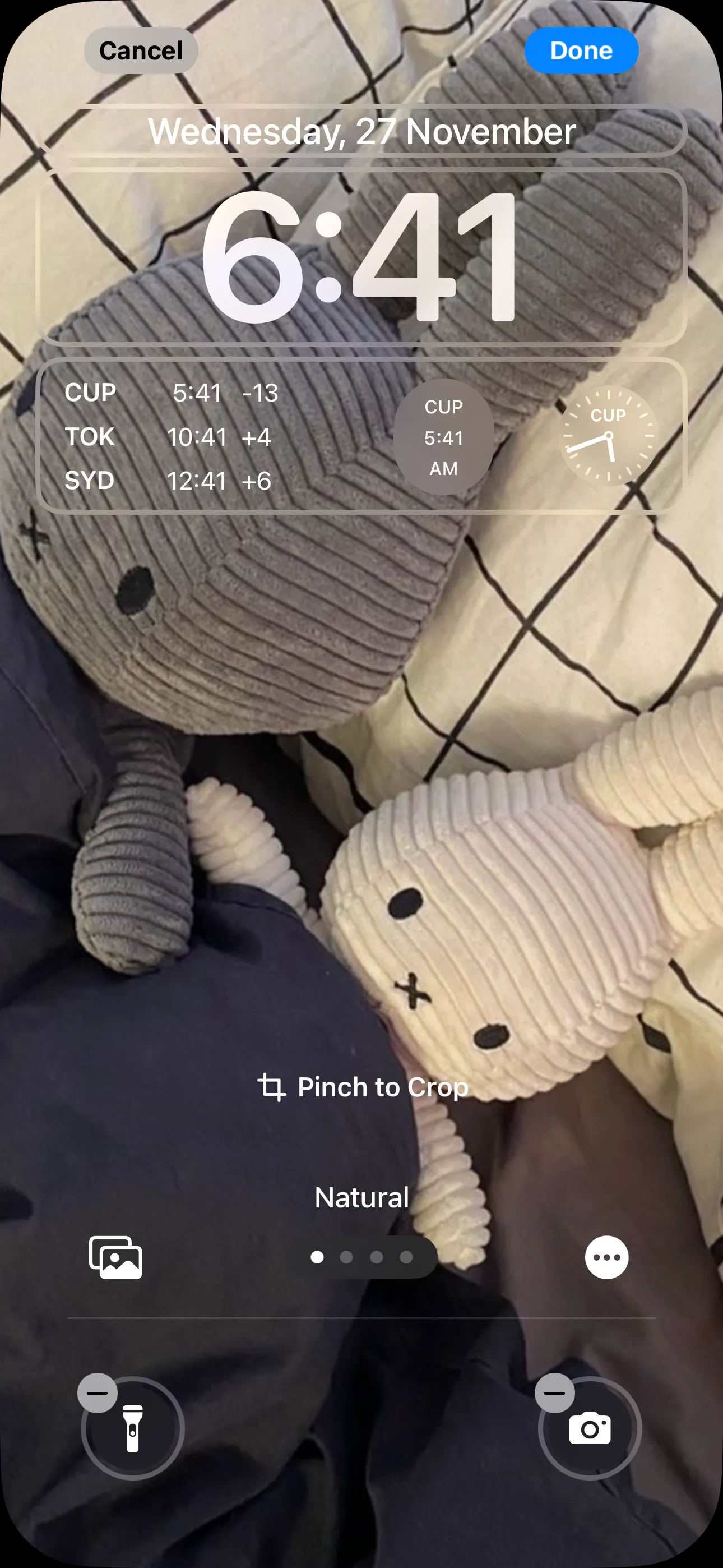 Màn hình khóa iPhone với nhiều widget đồng hồ hiển thị các múi giờ khác nhau