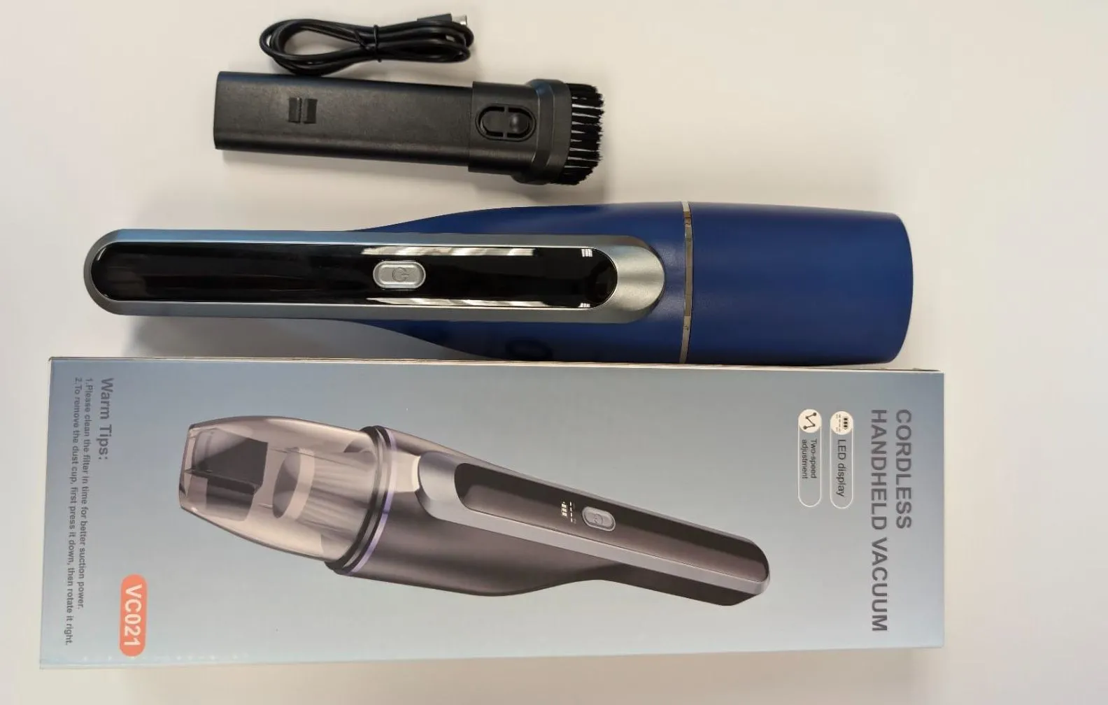 Máy hút bụi cầm tay không dây màu xanh dương, nhỏ gọn và có thể sạc lại qua cổng USB trên ô tô.